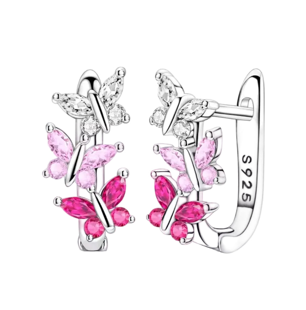 Butterfly-shaped earrings with pink gemstones on a white background